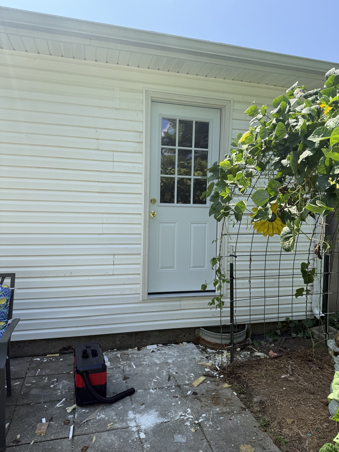 Completed exterior door and restored white siding
