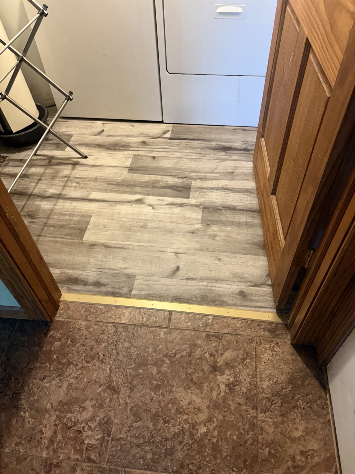 Finished flooring and transition at the laundry room doorway
